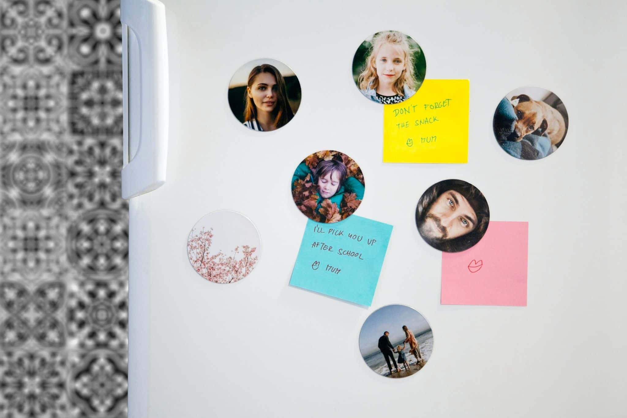 A refrigerator door covered in magnets, photos, and reminders.