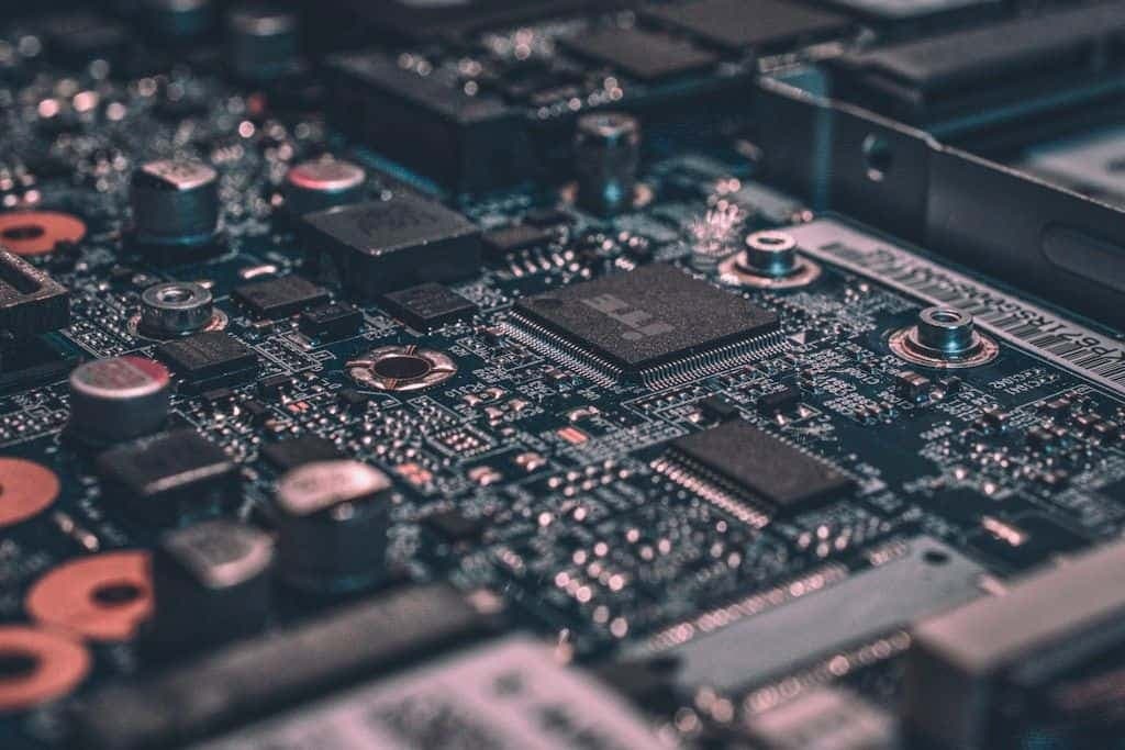 Macro close-up of a circuit board with a large chip package at the center.