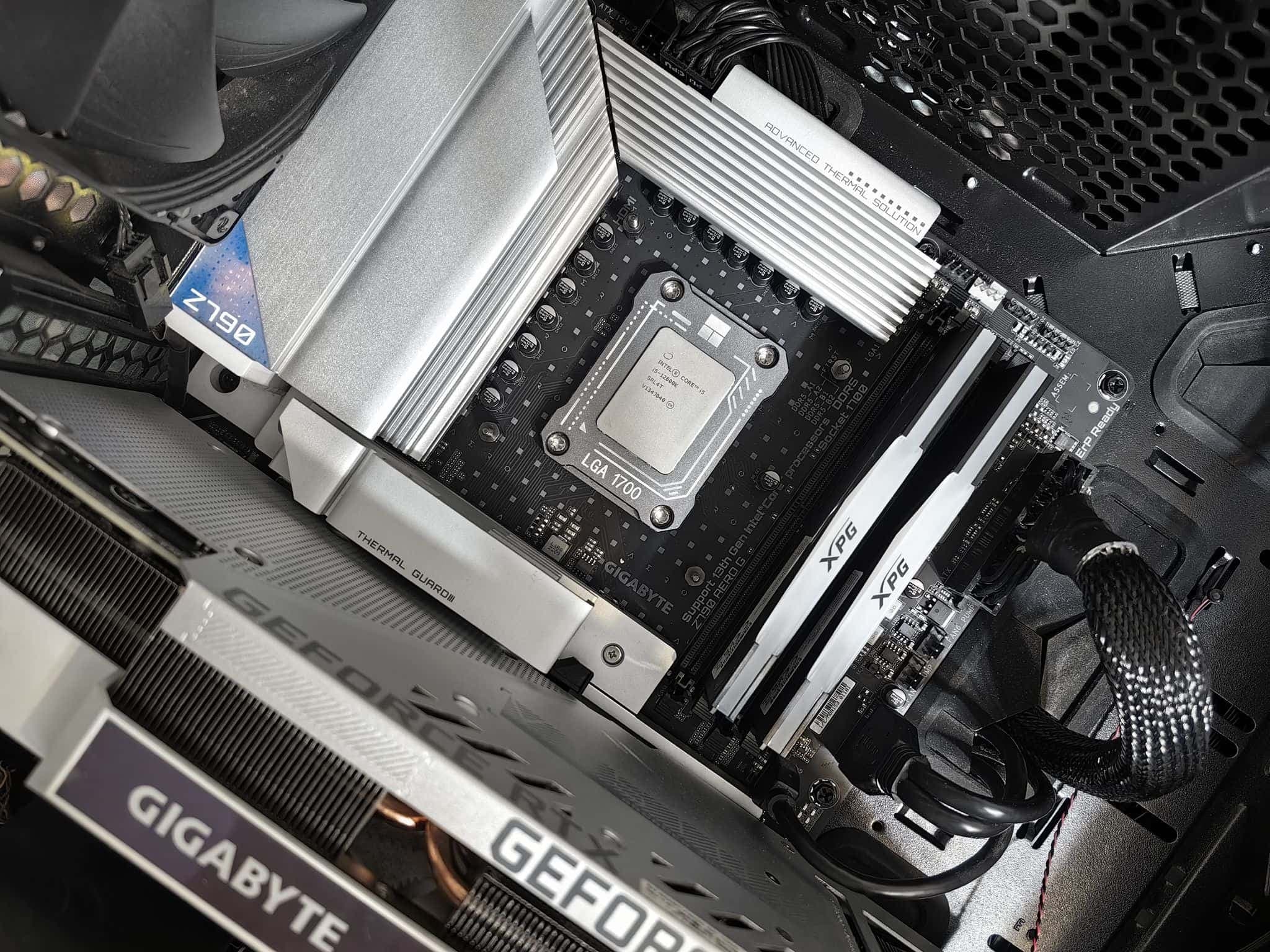 Inside of a desktop PC build: motherboard, CPU socket, RAM, and a GeForce RTX graphics card.
