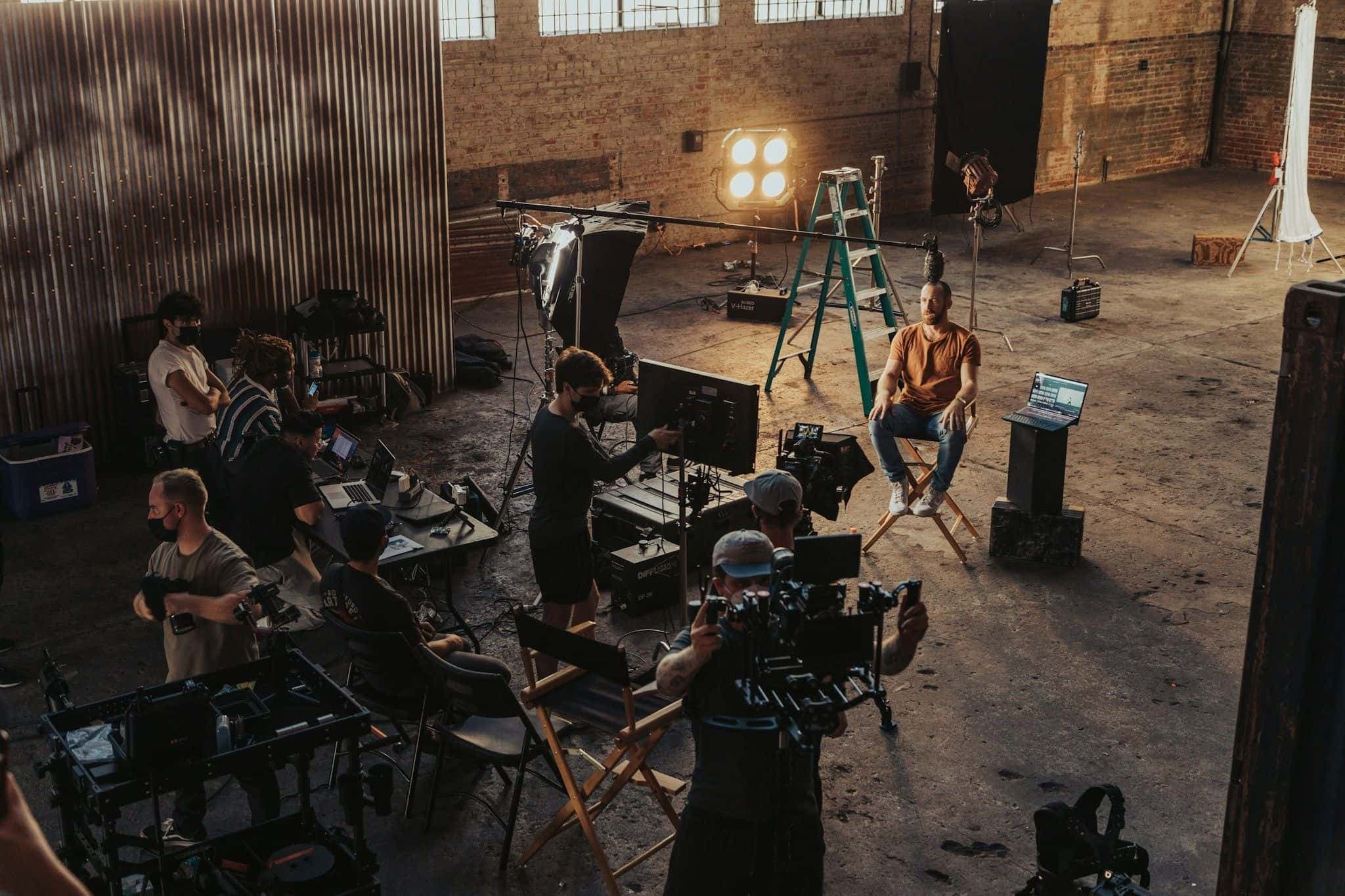 A small film crew gathered around a cinema camera rig on a set.