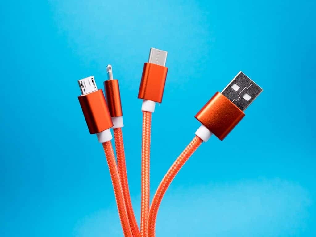 A neat row of identical orange USB connectors.