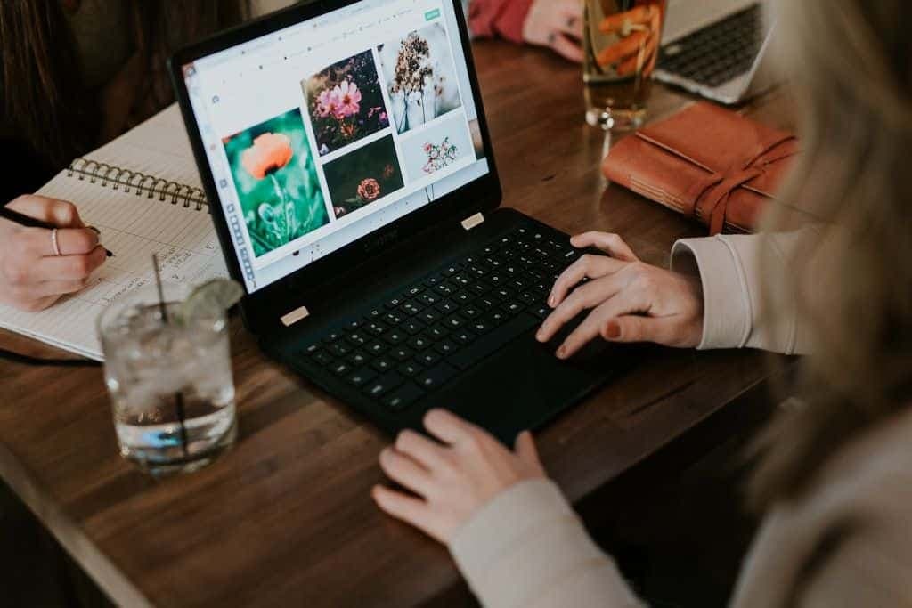 A person working at a desk on a laptop.
