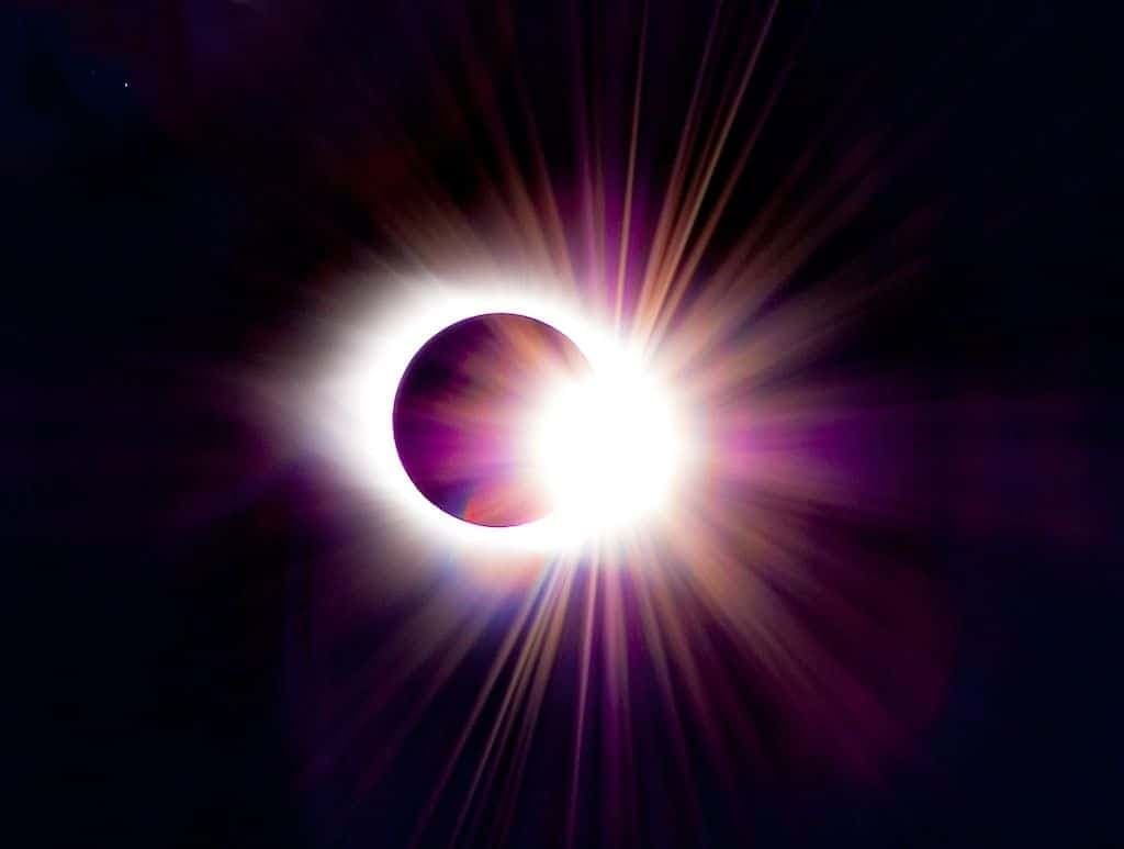A total solar eclipse: the sun's corona flaring around the dark disk of the moon.