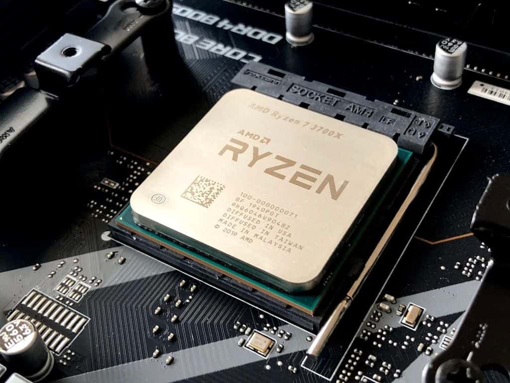 An AMD Ryzen processor seated on a black motherboard socket.