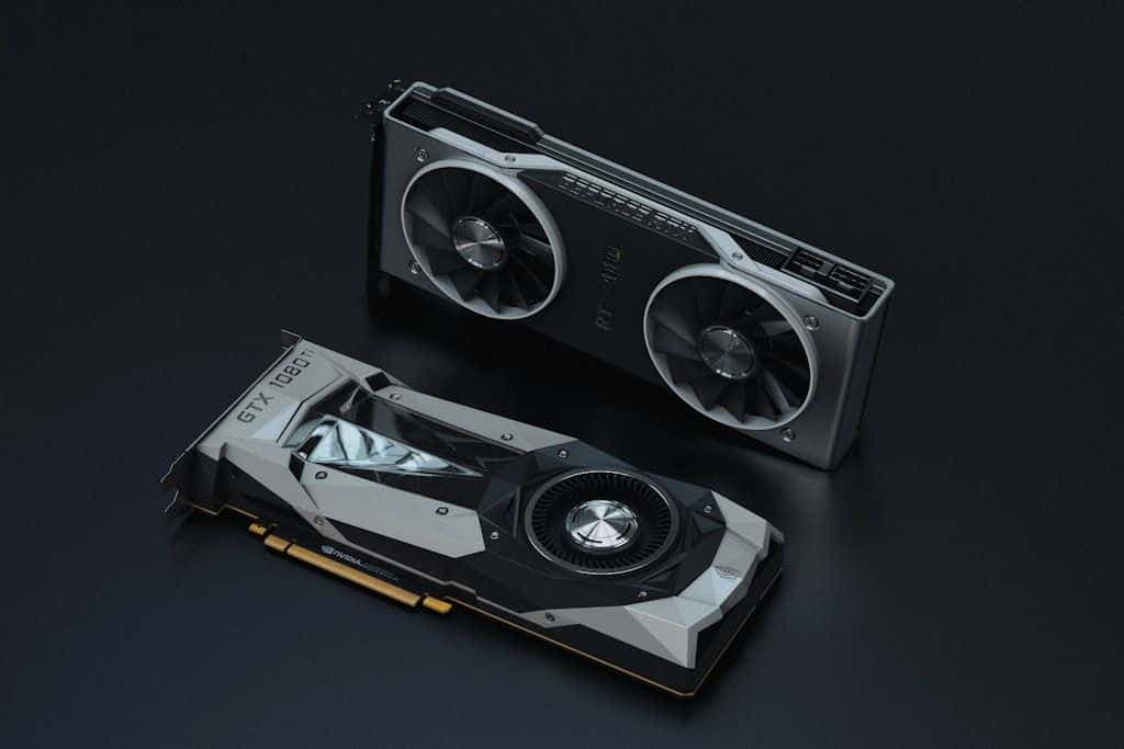 Two NVIDIA graphics cards lying on a dark surface.
