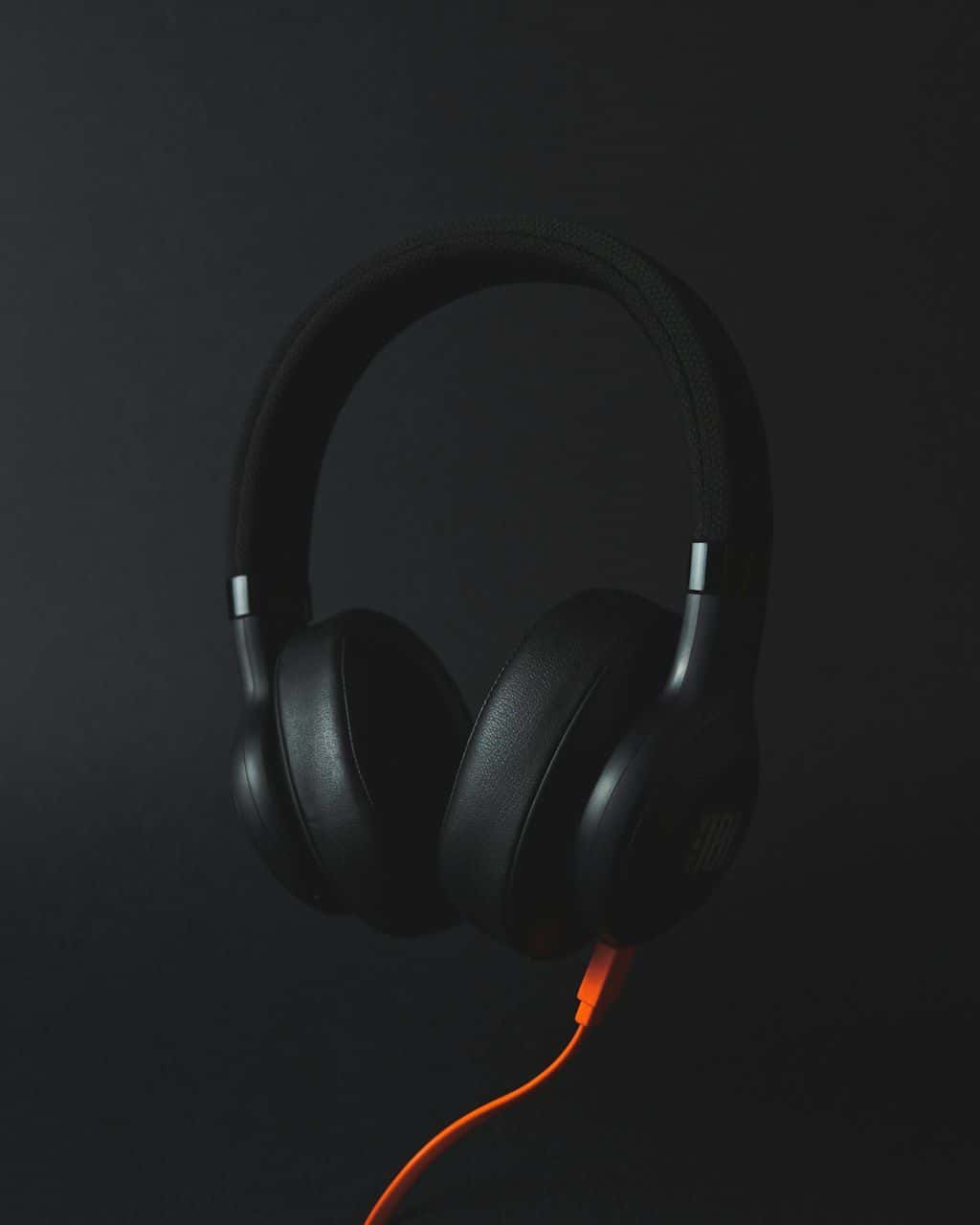 A pair of over-ear headphones resting on a table.