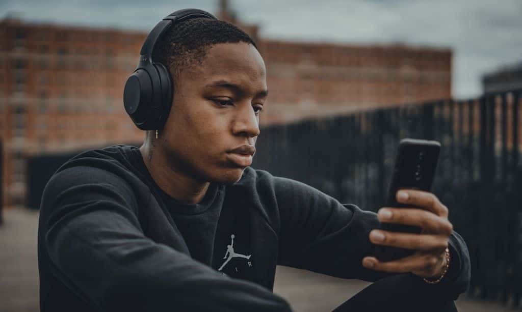 A person wearing headphones, listening.