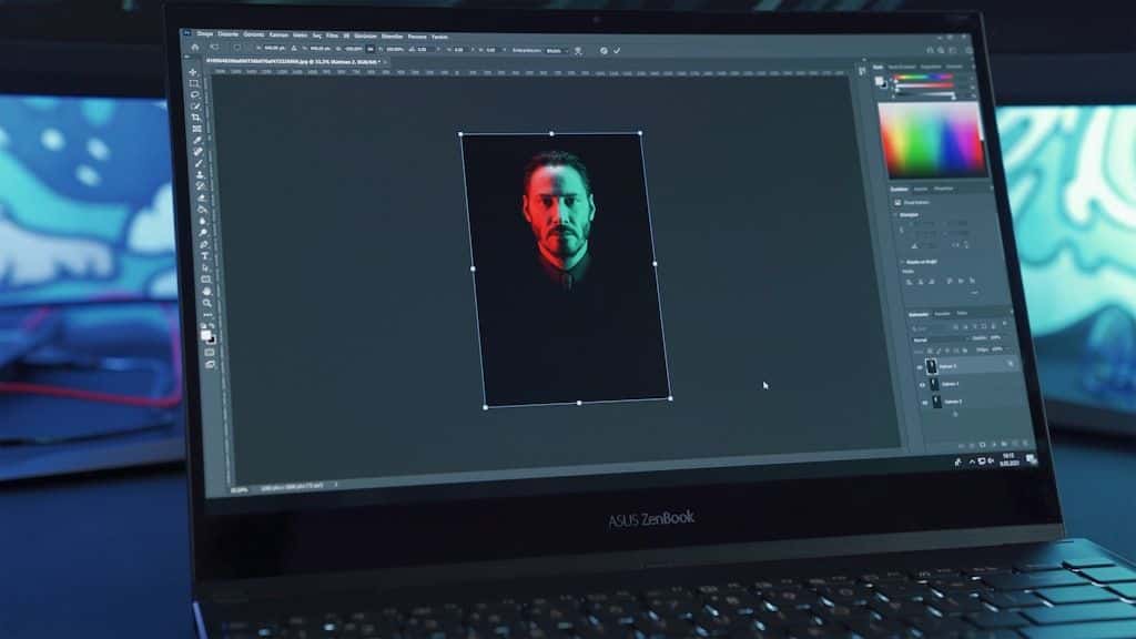 A laptop screen open to a photo-editing application, hands resting on the keyboard.