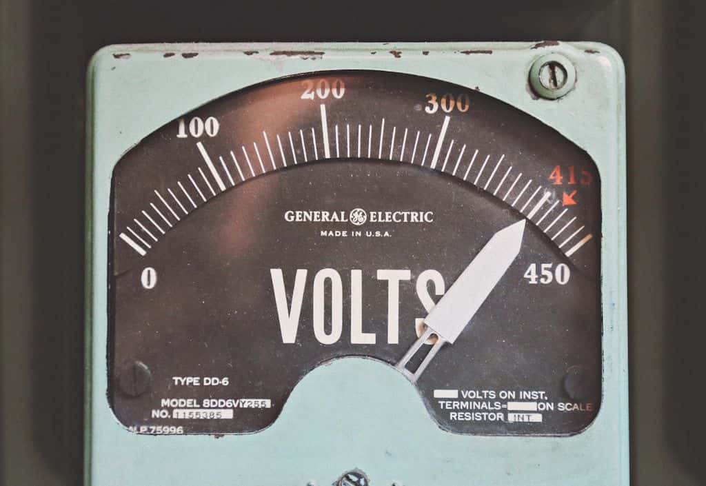 A vintage General Electric analog voltmeter with the needle high on the dial.
