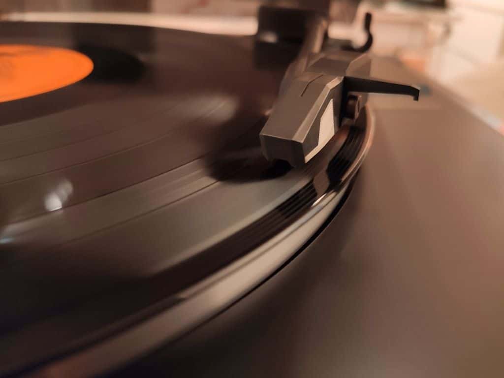 A record spinning on a turntable, the needle tracking the groove.