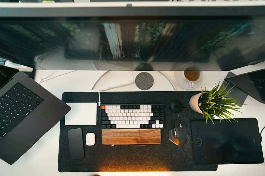 A clean and modern home-office desk with two monitors set up side by side.